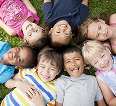 Group of happy kids laughing together outdoors