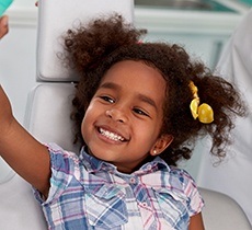 Happy little girl in dental chair