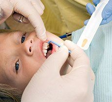 Child receiving fluoride treatment