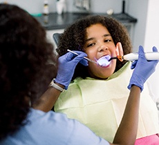 Young girl receiving dental bonding