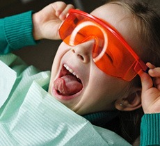 Child wearing safety glasses to prepare for Dental Bonding