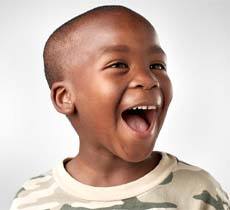 Smiling boy after children’s toothache treatment in Garland