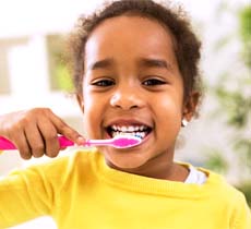 Child eating watermelon to prevent children’s dental emergencies in Garland