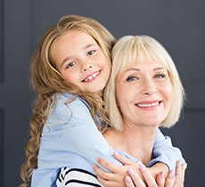 Young girl and her grandmother smiling