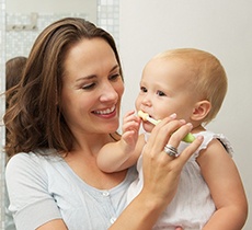 mom brushing baby’s teeth