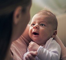 Baby looking up at mother