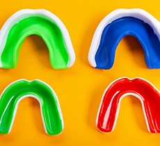 Four mouthguards on yellow background