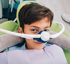 A young boy wears a mask to receive nitrous oxide sedation in Garland