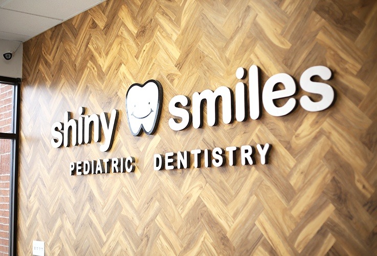 Shiny Smiles Pediatric Dentistry wall logo