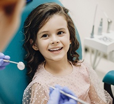 Young girl smiling at dentist during dental checkup