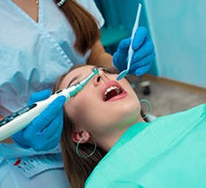 Young patient relaxing in reclined dental chair with IV dental sedation