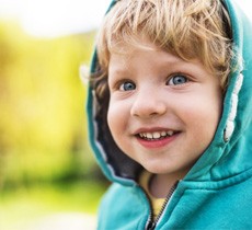 Child smiling with space maintainer in Garland 