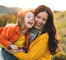 A mom and daughter laughing in Garland   