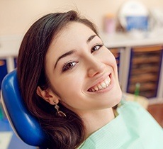 Smiling young woman in dental chair