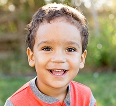 Little boy smiling outdoors