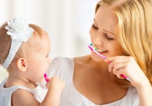 mommy and baby brushing teeth together