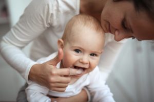 Mom brushing baby's teeth