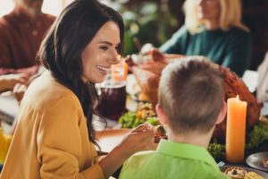 Mother eating with child using tips from children’s dentist in Garland