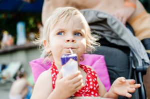 Inquisitive child drinking from a juice box