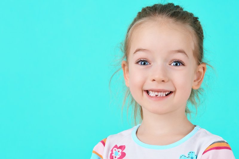 young girl with an extracted tooth