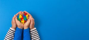 hands holding puzzle pieces for special needs dentistry