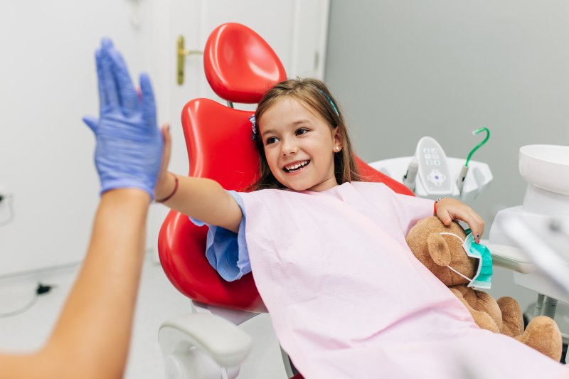 Cute little girl high-fives dentist