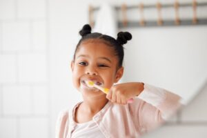 Young girl brushing her teeth