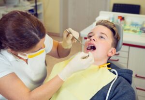 Dentist working on teenage patient.